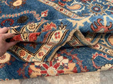 Vintage Oushak Hand Knotted Wool Rug in deep navy blue with floral medallions, botanical motifs, and ornate cream and red borders