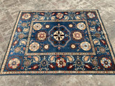 Vintage Oushak Hand Knotted Wool Rug with a deep navy blue field featuring large floral medallions, intricate botanicals, and an ornate cream border
