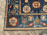 Vintage Oushak Hand Knotted Wool Rug with deep navy blue background, large floral medallions, intricate cream, red, terracotta, and blue botanical motifs