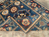 Vintage Oushak Hand Knotted Wool Rug with deep navy blue field, large floral medallions, and ornate cream border