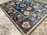 Vintage Oushak Hand Knotted Wool Rug with a navy blue field featuring large floral medallions and intricate botanical motifs in cream, ivory, red, and terracotta hues