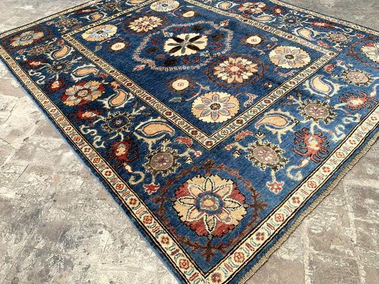 Vintage Oushak Hand Knotted Wool Rug with a navy blue field featuring large floral medallions and intricate botanical motifs in cream, ivory, red, and terracotta hues