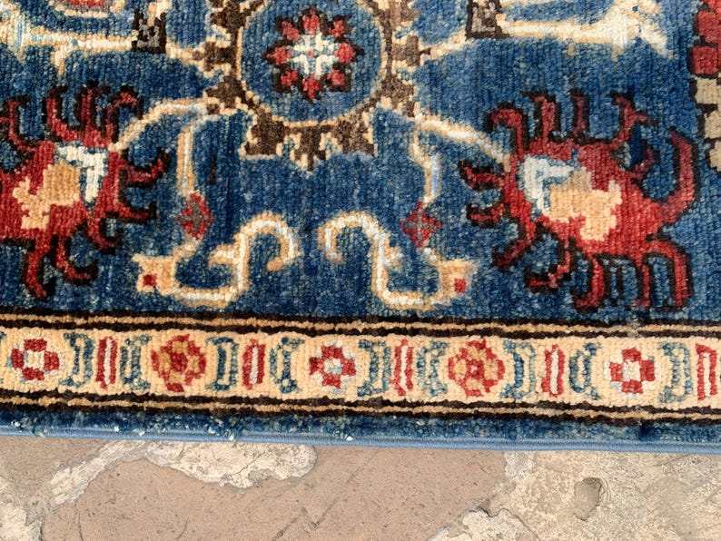Vintage Oushak Hand Knotted Wool Rug with deep navy blue, cream, red, and brown floral and botanical motifs in a traditional ornate pattern