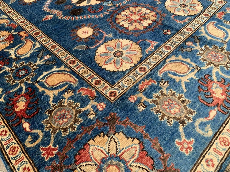 Vintage Oushak Hand Knotted Wool Rug with deep navy blue field, large floral medallions, botanical motifs, and ornate borders in cream, red, and terracotta