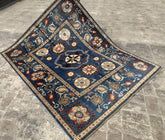 Vintage Oushak Hand Knotted Wool Rug in deep navy blue featuring large floral medallions and intricate botanical patterns with cream and red accents