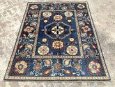 Vintage Oushak Hand Knotted Wool Rug with deep navy blue background, large floral medallions, and intricate cream and red botanical patterns