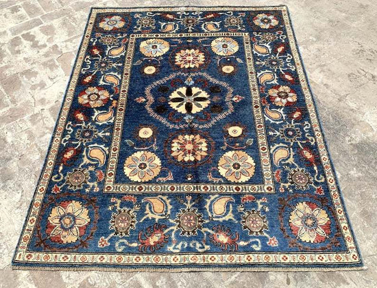 Vintage Oushak Hand Knotted Wool Rug with deep navy blue background, large floral medallions, and intricate cream and red botanical patterns