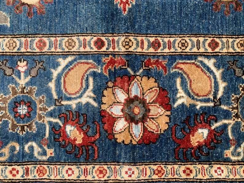 Vintage Oushak Hand Knotted Wool Rug featuring deep navy blue field with large floral medallions, botanical motifs, and an ornate cream border